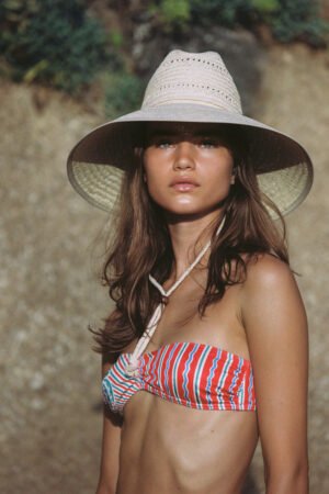 Model wearing The Vista straw cowboy hat, showcasing its design and fit.